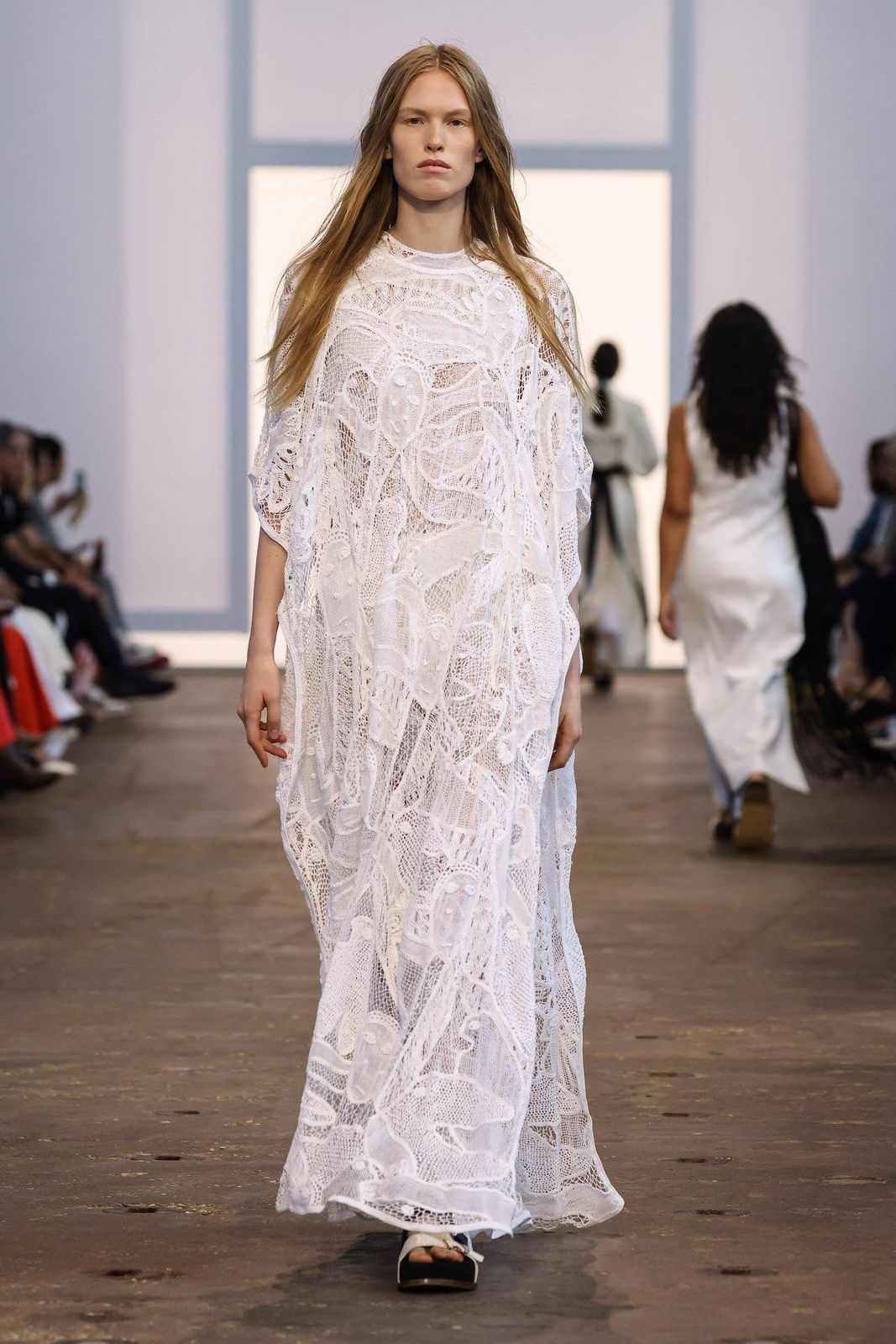 Model wearing the white Solrou-inspired macrame gown on the Gabriela Hearst Spring Summer 2024 runway